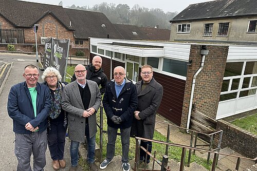 Six people in front of youth club