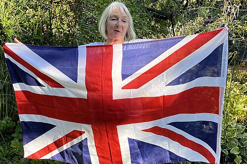 Cllr Kathryn Field holding a Union Jack Flag