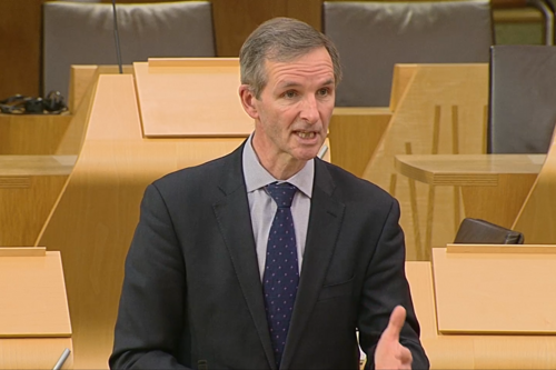 McArthur speaking in chamber