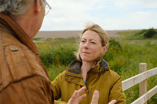 Charlotte FitzGerald listening to a local resident