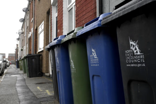 Recycling and household waste bins outside homes in North East Lincolnshire.