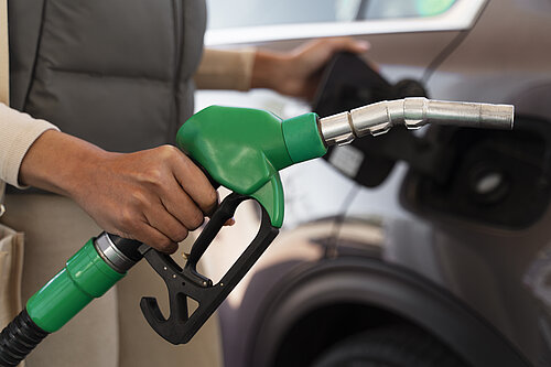 A person filling their car with petrol.