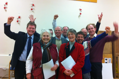 "Elizabeth Miles and Val Shaw are cheered by supporters as the result is announced."