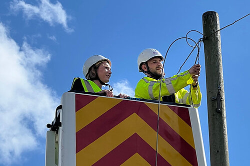 Helen Morgan with a broadband engineer in a cherry picker truck