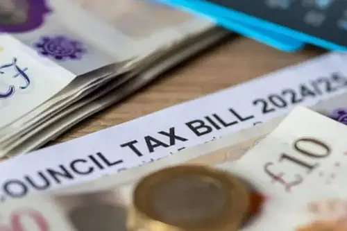 cash on table next to council tax bill