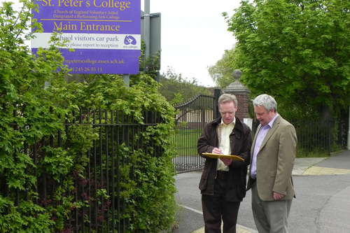 Cllr Stephen Robinson and Cllr Paul Bentham looking at a clipboard in front of the former St Peter's college