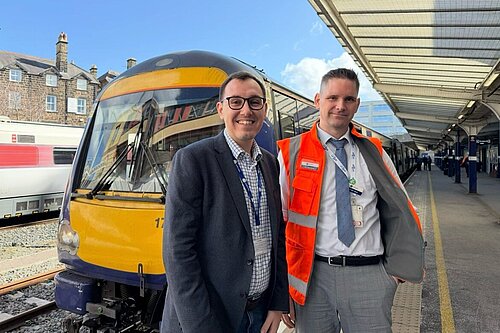 Tom Gordon stood in front of a train at Harrogate station