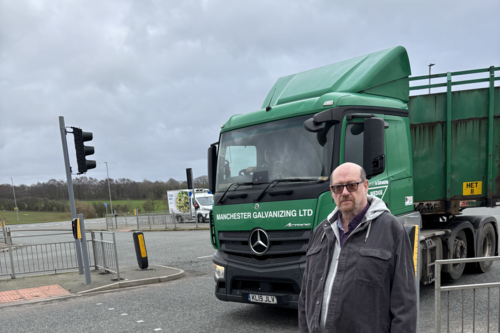 Iain with lorries passing from WEII Way onto Manchester Road
