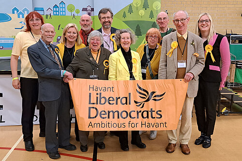 Members of the Havant Lib Dem holding the Havant Lib Dem banner