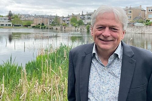 Kevin Mckay standing in front of the Union Canal, with houses in the background