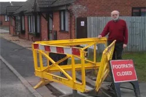 Bill Lewis inspecting repair at Mellish Court