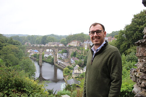 Tom Gordon MP standing near viaduct.