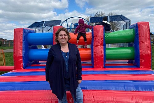 Jane Carr standing in front of a bouncy castle in at a Play Association event in Newport Pagnell