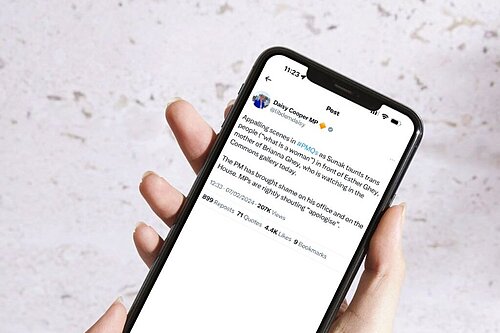 Screenshot of a Tweet from Daisy Cooper on a phone reading "Appalling scenes in #PMQs as Sunak taunts trans people (“what is a woman”) in front of Esther Ghey, mother of Brianna Ghey, who is watching in the Commons gallery today.  The PM has brought shame on his office and on the House. MPs are rightly shouting “apologise”."