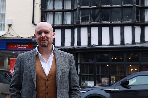 Cameron outside Tudor building