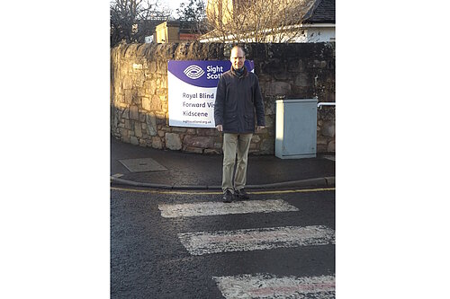 Neil standing on a zebra crossing