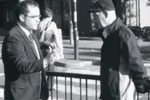 James Gardner at zebra crossing discussing traffic problems with resident