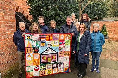 Helen with the MDCA group and their quilt