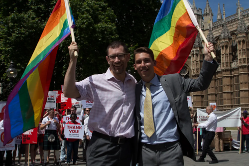 LGBT+ Lib Dems vice-chair Ed Fordham (left) and chair Adrian Trett wave rainbow flags during the Third Lords Reading of the Marriage (Same Sex Couples) Bill