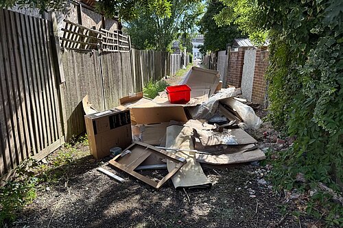 A red plastic box on a pile of rubbish