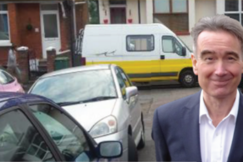 Stephen Conway next to double parked cars