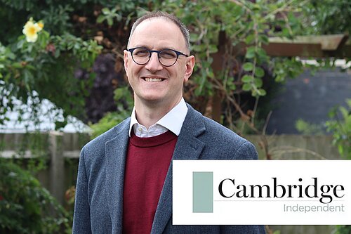 Ian Sollom MP in front of nature with the Cambridge Indepedent logo emblazoned on the bottom right