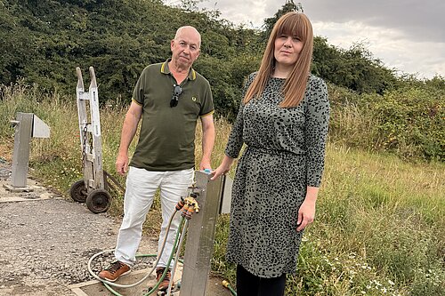 Cllr Nicola Aisthorpe and Lib Dem campaigner Brian Barrett beside a working water standpipe at Carr Lane allotments.