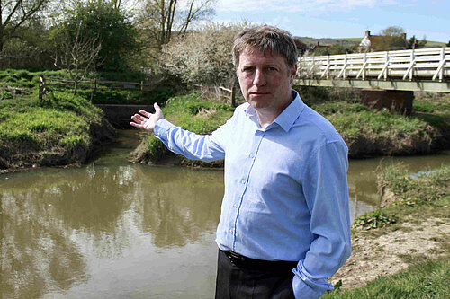 James gesturing towards the sewage filled stream at Cuckmere Point