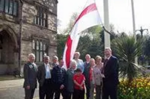 St George flag being raised outside Rochdale Town Hall with the Leader of Rochdale Council, Alan Taylor
