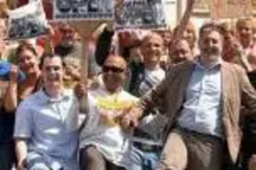 Lib Dem Councillors and members of the public waggle their toes in protest at the closure of Buersil Post Office