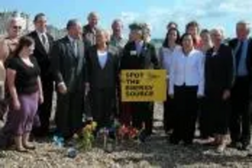 Fiona Hall MEP and North East Lib Dems on beach demonstrating wind, sun & waves as energy sources.