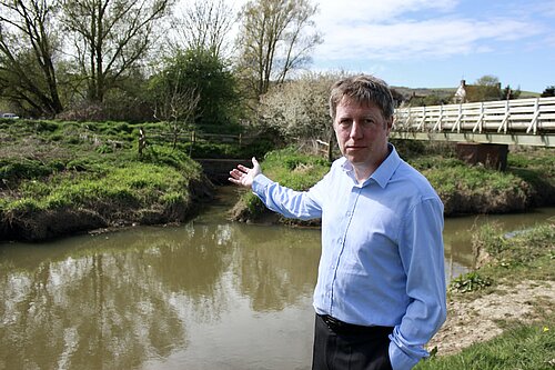 James gesturing towards the sewage filled stream at Cuckmere Point
