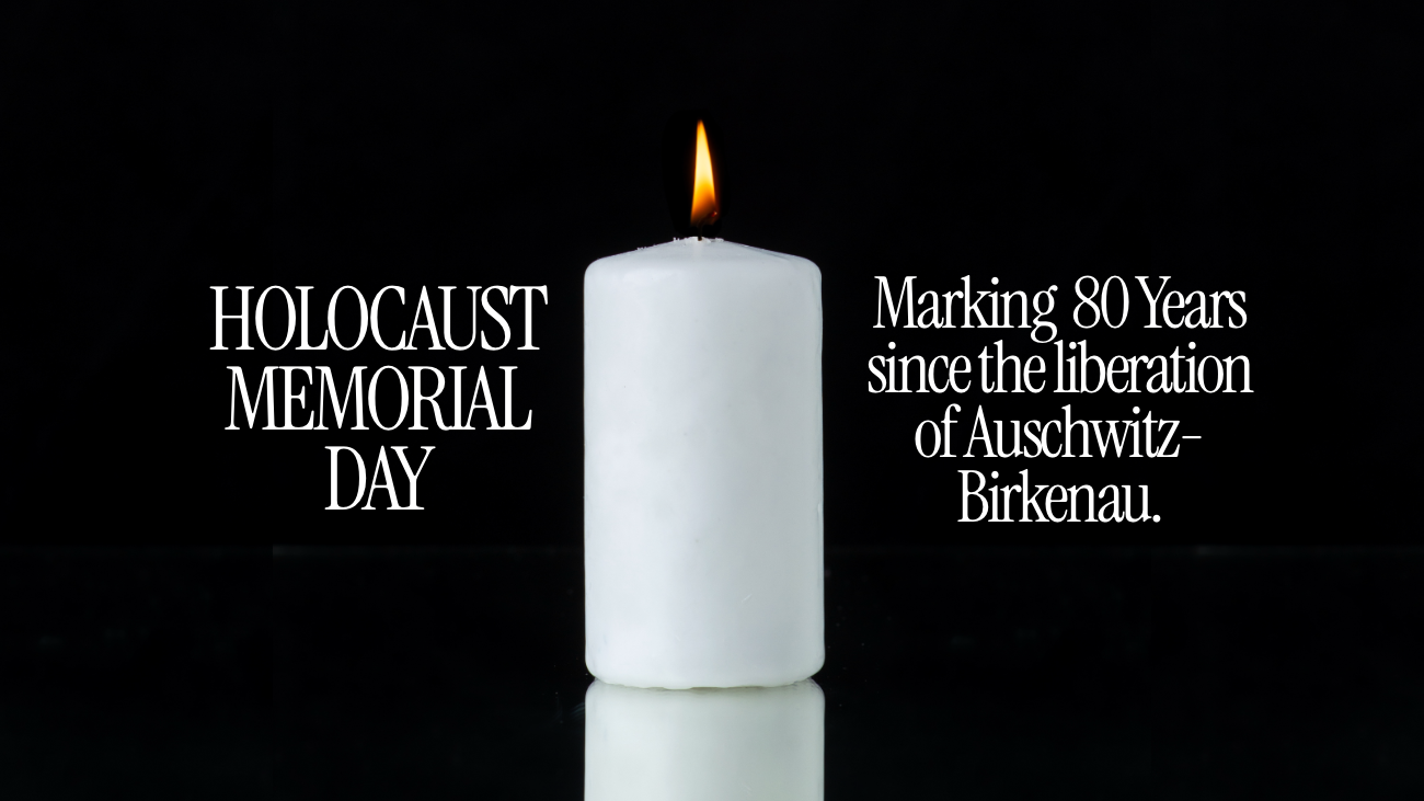 A burning white pillar candle with text either side reading Holocaust Memorial Day and Marking 80 Years since the liberation of Auschwitz-Birkenau
